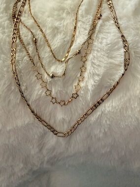 four gold necklaces